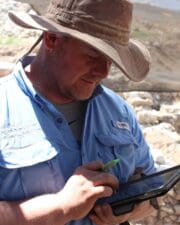 Alumnus Tommy Chamberlin taking notes in Israel