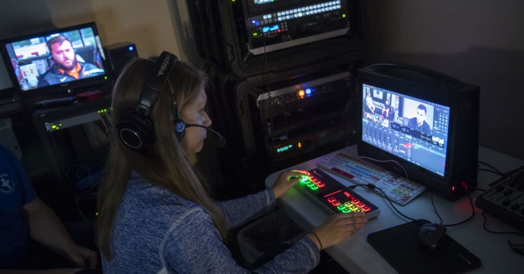 Student working a switchboard in Film & Media Arts class.