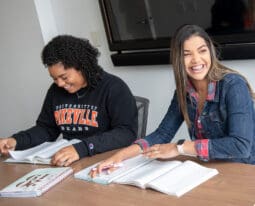 Two students studying at a table.