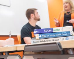Students taking notes during a social work class.