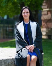 UPIKE criminal justice alumnus Ashley Cook sits on campus before commencement
