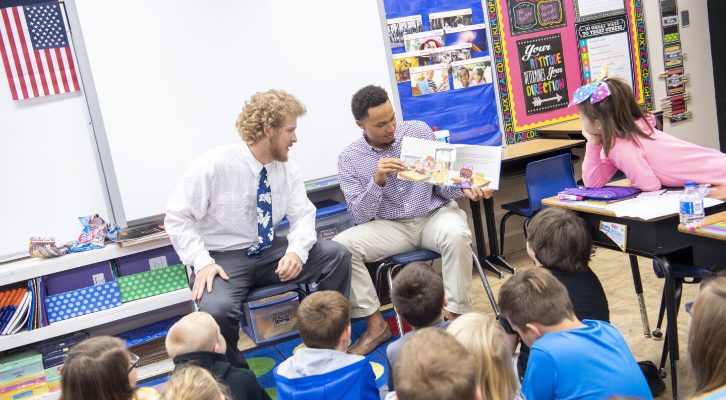 students reading to elementary class