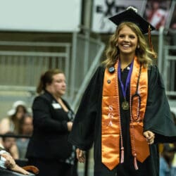 nursing student walking across stage during commencement