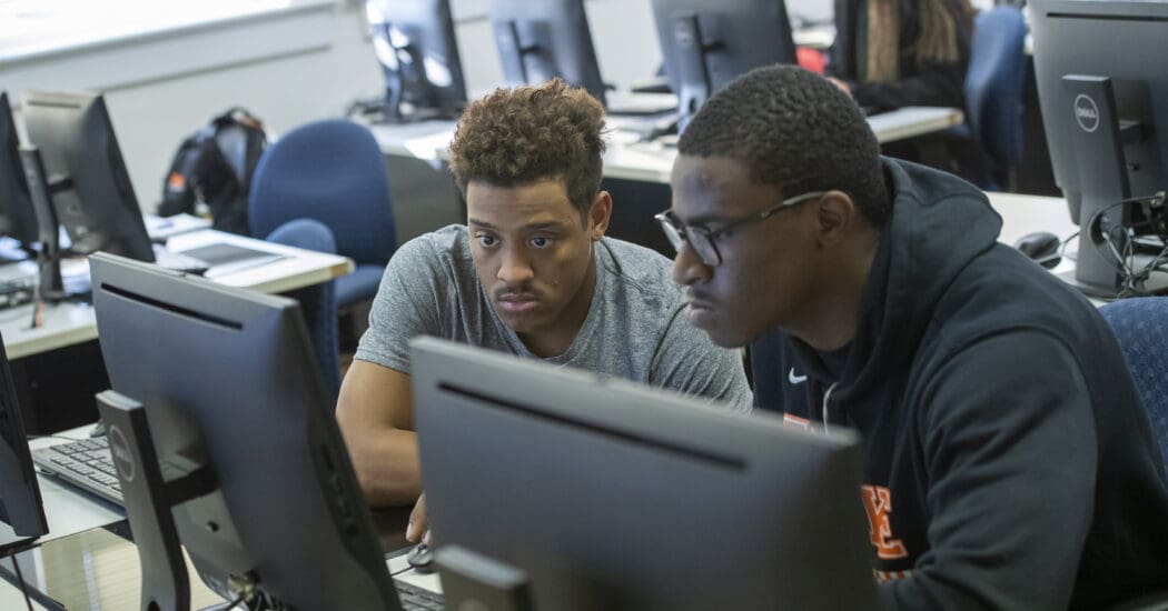 computer science students working on coding in classroom