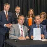 Administration from University of Pikeville and Pikeville Medical Center holding memorandum of agreement at signing event.