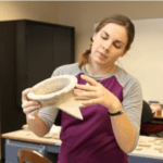 student abigail levitt holding historial piece from biblical times