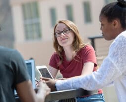 Students studying on Benefactors Plaza.