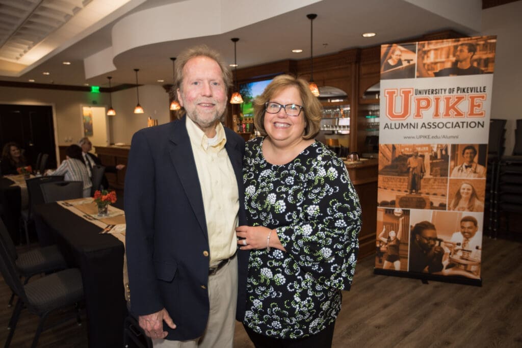 couple in front of the UPIKE banner