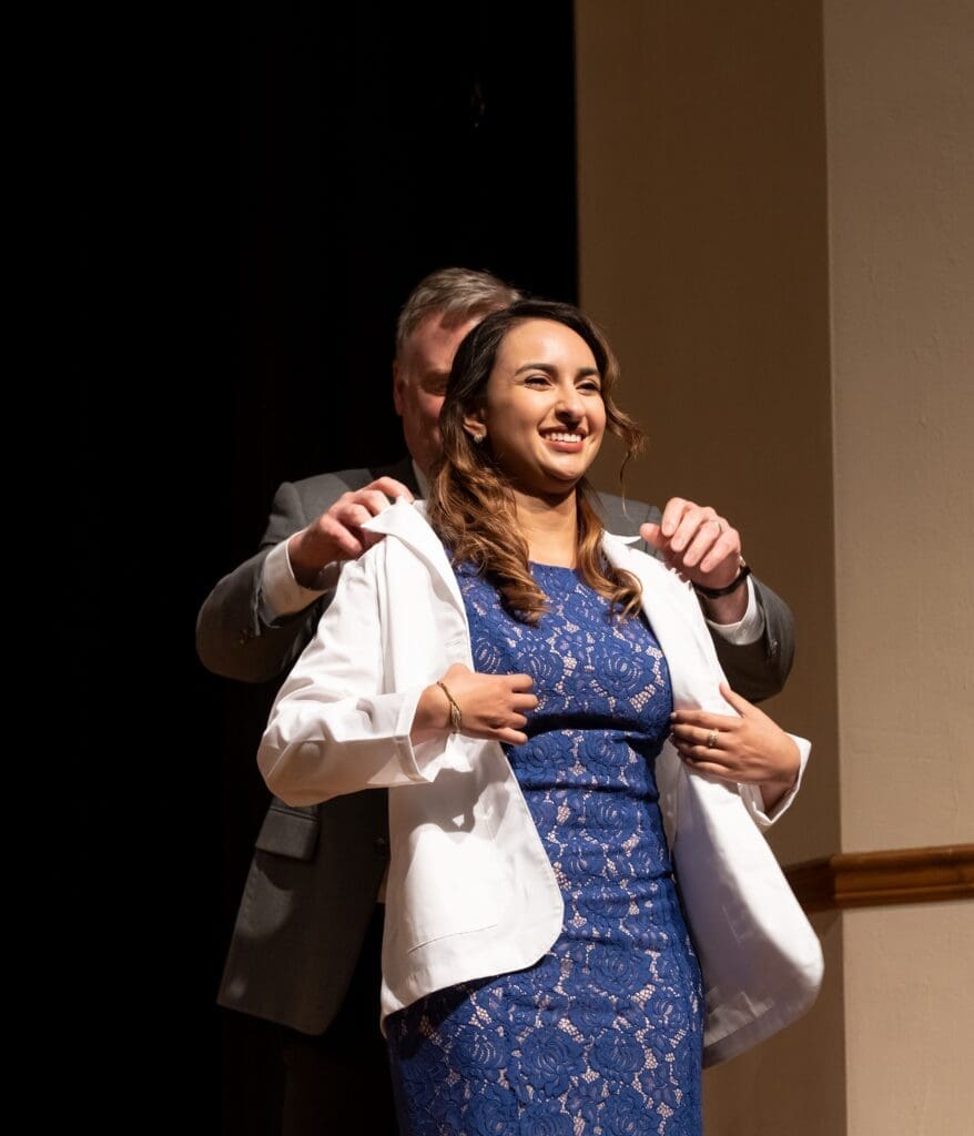 Sandra Maria Rugama, University of Pikeville-Kentucky College of Optometry student, receives her symbolic white coat signifying her entry into clinical training.