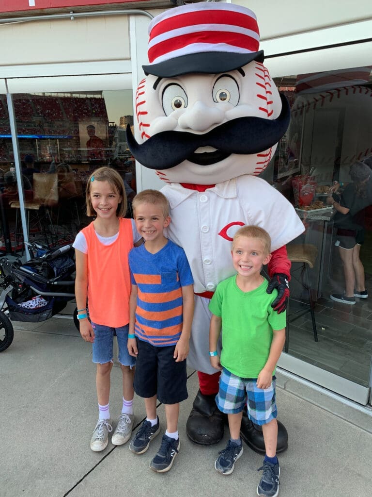 Three young fans with mascot