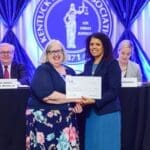 Allison J. Donovan, KBF secretary-treasurer for fiscal year 2018-2019, right, presents a check to Nancy Cade, Ph.D., during the Kentucky Bar Foundation Fellows & Partners for Justice Society Luncheon, held Thursday, June 13 in Louisville.