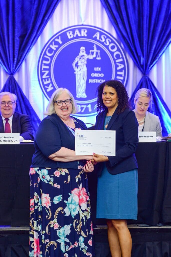 Allison J. Donovan, KBF secretary-treasurer for fiscal year 2018-2019, right, presents a check to Nancy Cade, Ph.D., during the Kentucky Bar Foundation Fellows & Partners for Justice Society Luncheon, held Thursday, June 13 in Louisville.