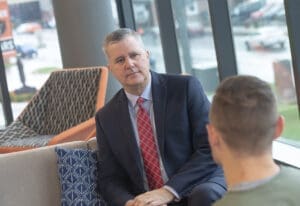 Dean Bacigalupi sitting with student