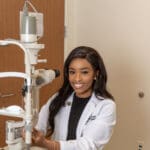 Sha' Mia poses with optometry equipment
