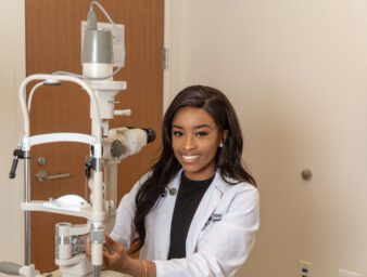 Sha' Mia poses with optometry equipment