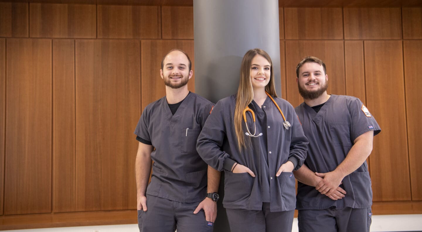three nursing students standing