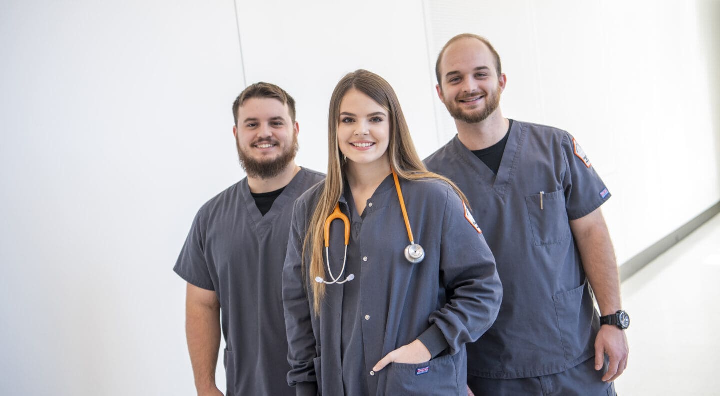 three nursing students standing