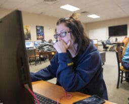 student using computer in art class