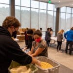Students at a table packaging meals