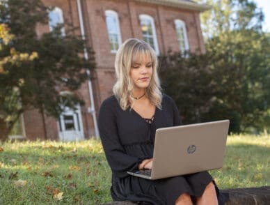 Student outside on a laptop