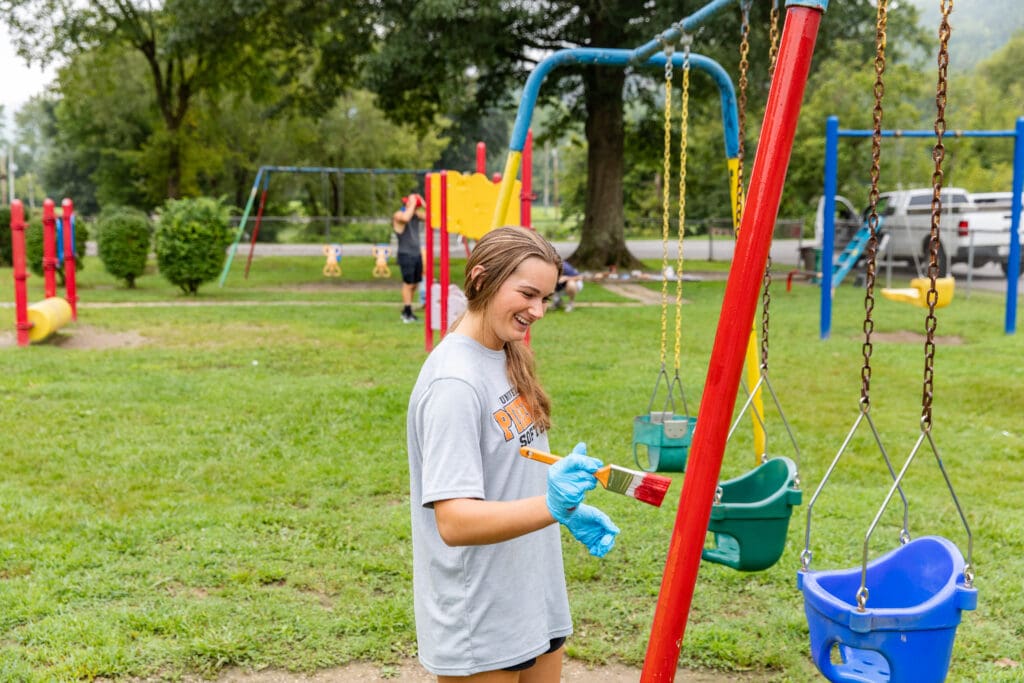 student painting playground during service day 2021