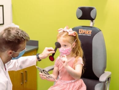 pediatric patient sitting in optometry clinic chair