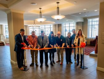 City and university leaders cut a ribbon at Table 99 on UPIKE's campus