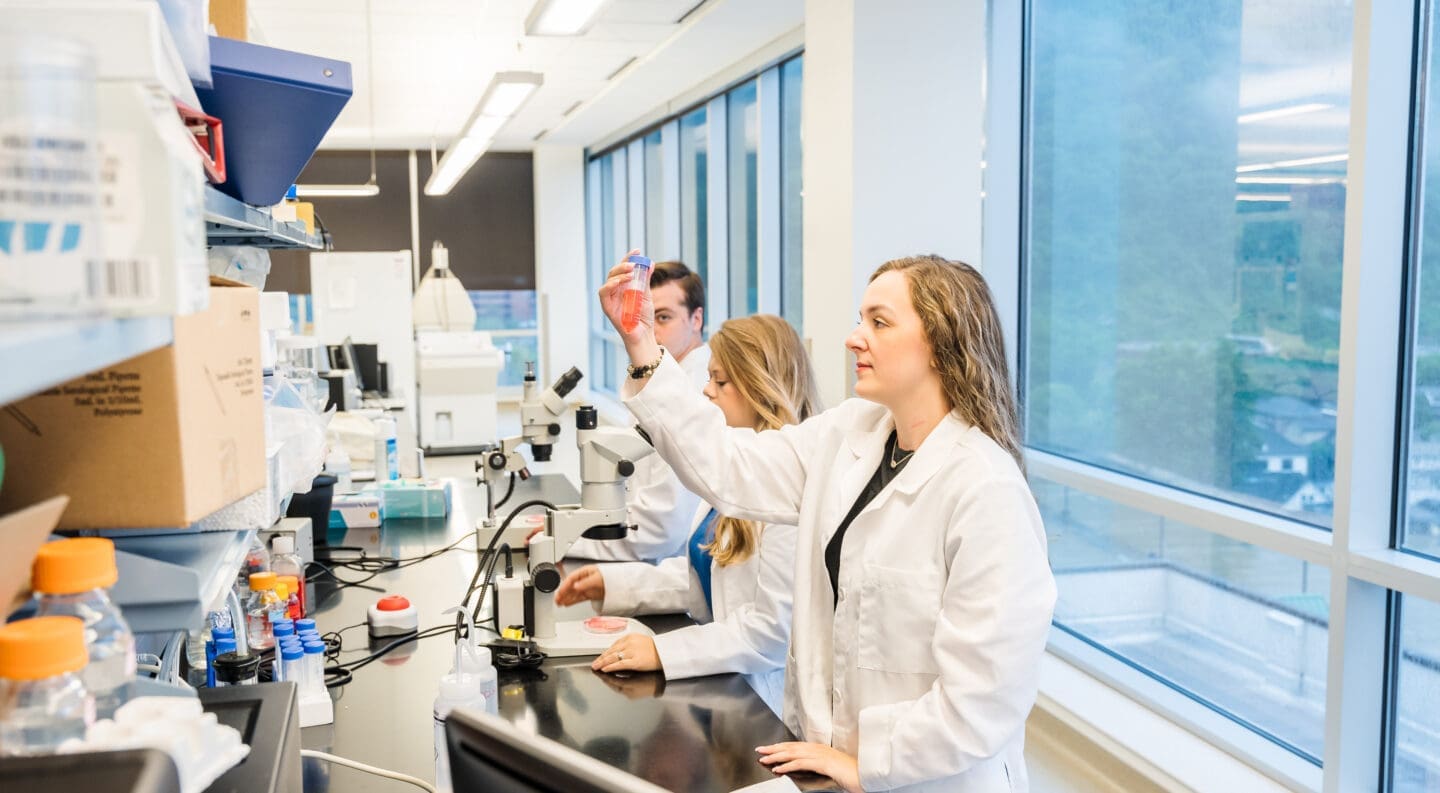 three undergrad students doing summer research in med school research lab