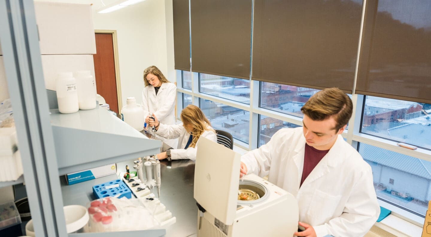 three undergrad students doing summer research in med school research lab