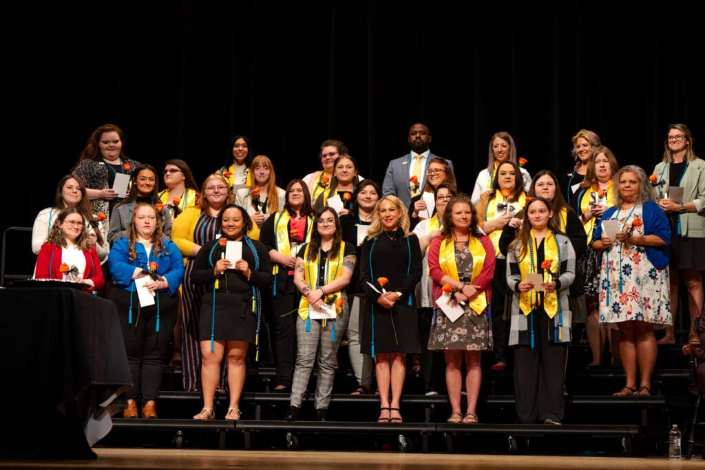 social work students standing on the stage during their pinning ceremony