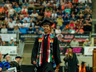 Ivan Perez crosses the stage at commencement