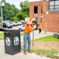 freshmen students work outside during service day