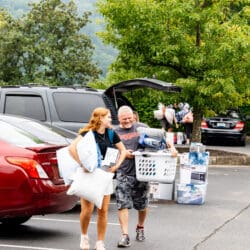 father and daughter smile at each other during freshmen move in day