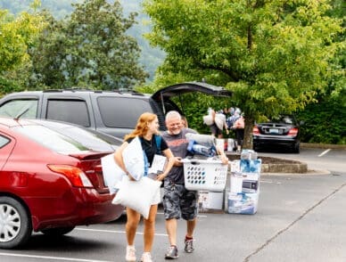father and daughter smile at each other during freshmen move in day