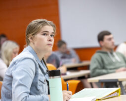 student is seen taking notes during a class period