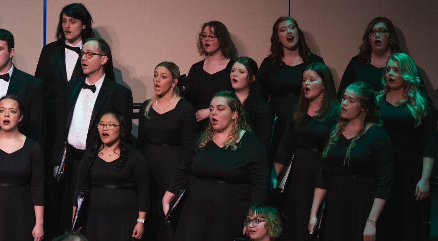 Choir singing with green lighting to the right