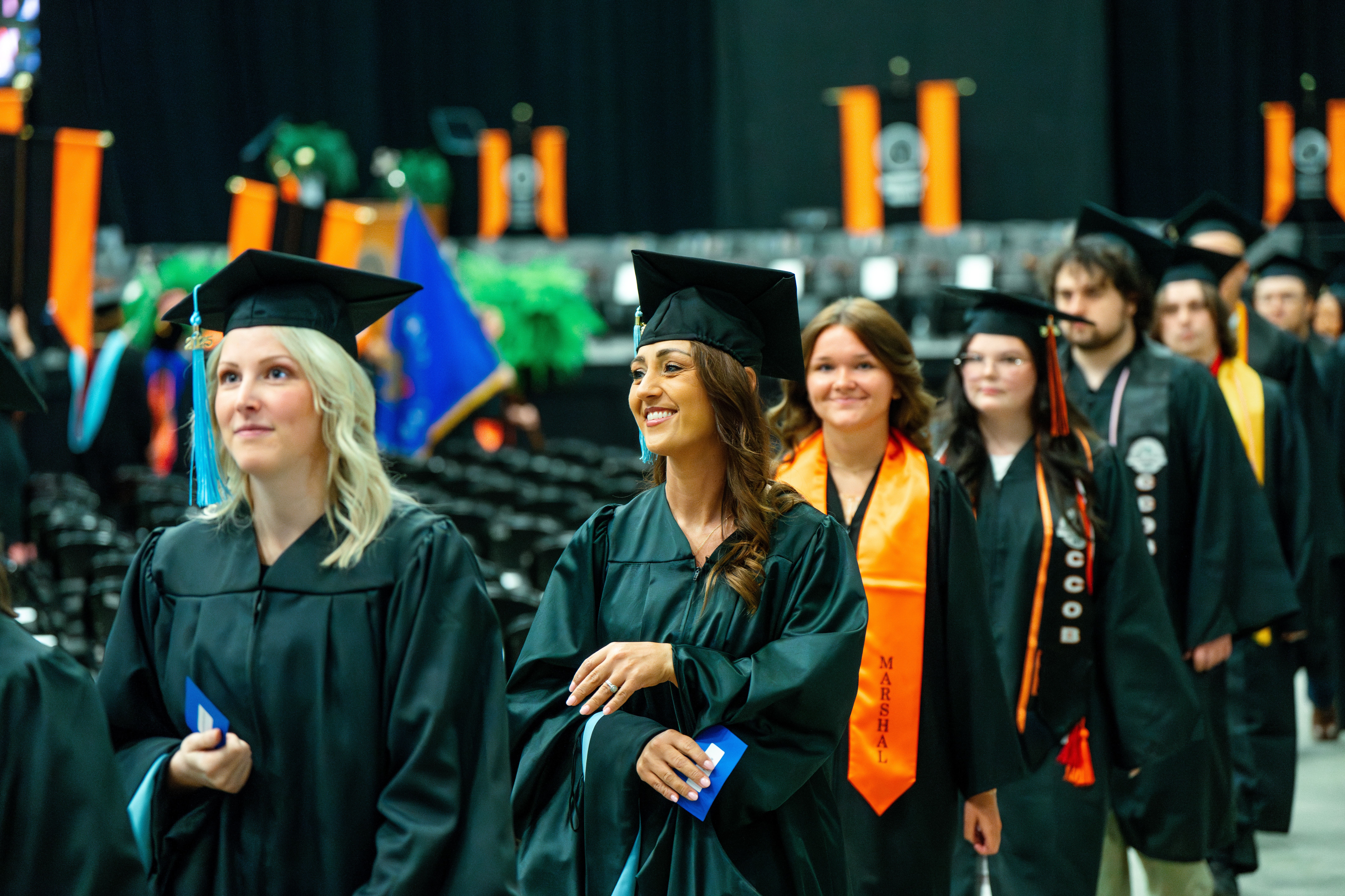 Undergraduate students walking in to take their seats at the ceremony.