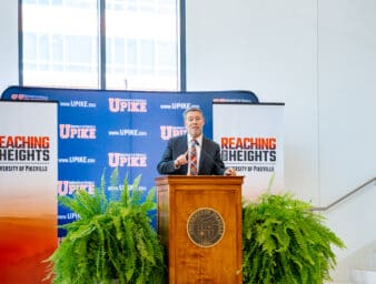 President Burton Webb at the podium