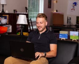 graduate student working on a laptop/online