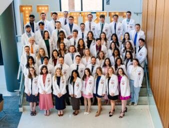 KYCO Class of 2028 posed posed together on stairs for group photo.